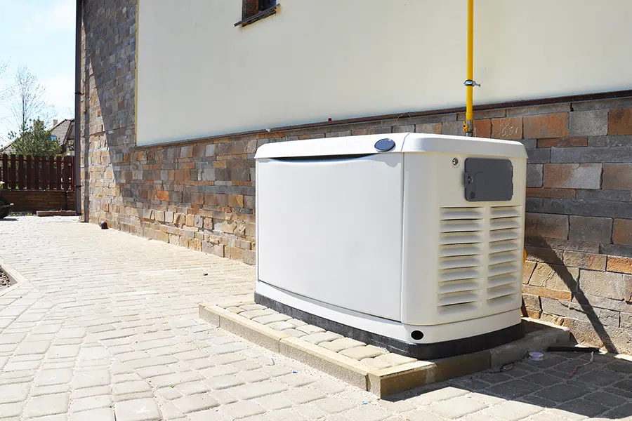 Backup generator system positioned on a concrete pad outside a Wilson, North Carolina home.