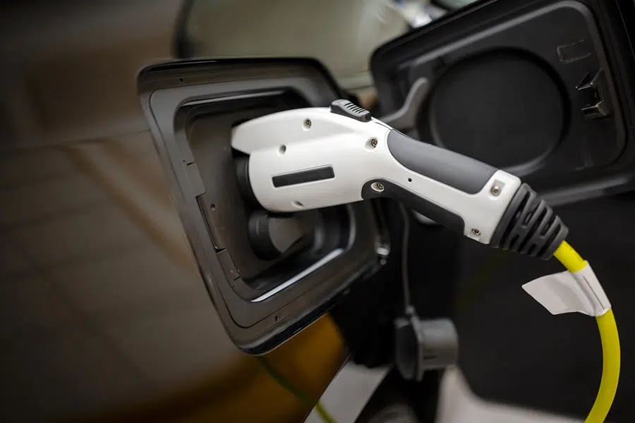 Close-up of EV charging plug connected to an electric vehicle at a Wilson, NC residence.
