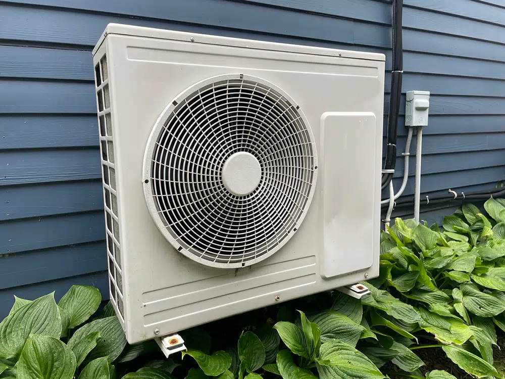 Outdoor mini split heat pump unit mounted beside a home in the Wilson, NC area.