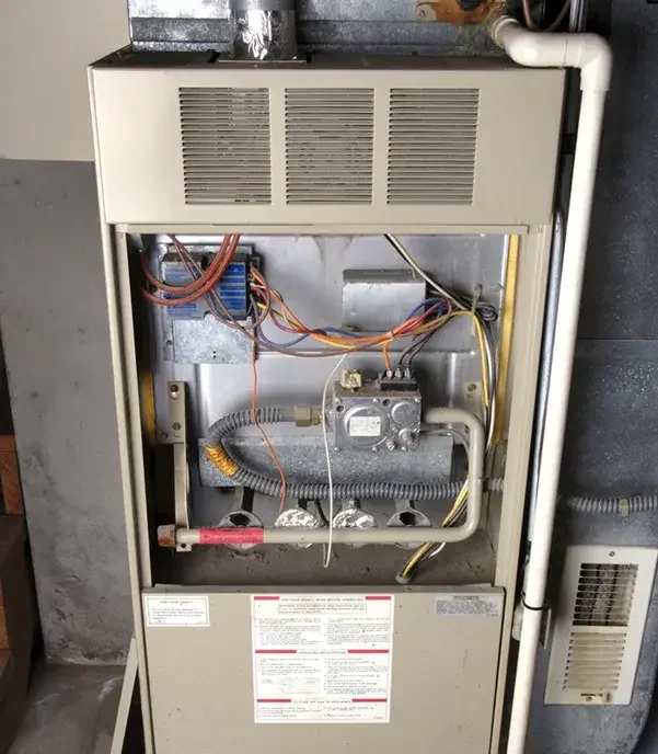 inside of furnace that needs repair in Wilson home