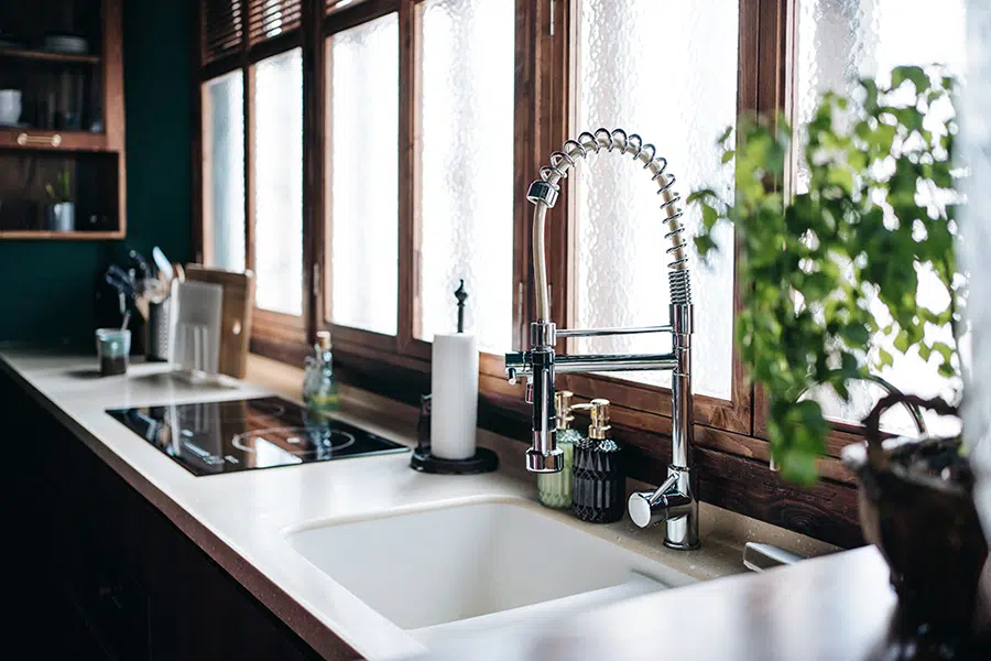 Modern kitchen sink and faucet installed in a residential home located in Wilson, North Carolina.