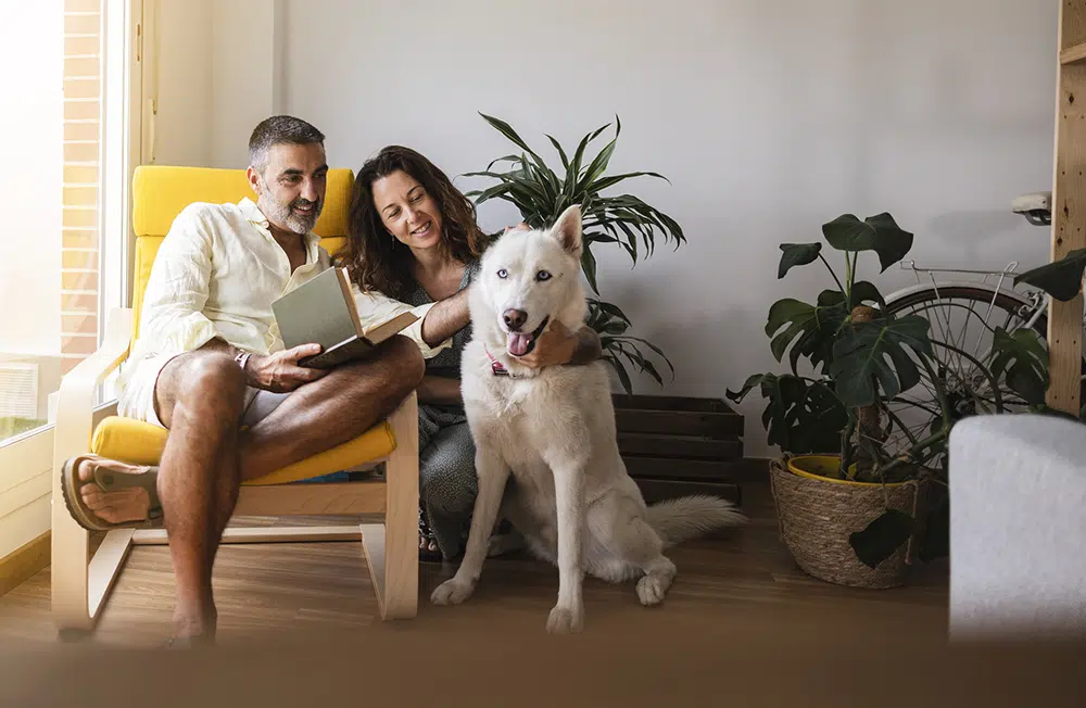 Homeowners relaxing with their dog in a comfortable living space in Wilson, North Carolina.