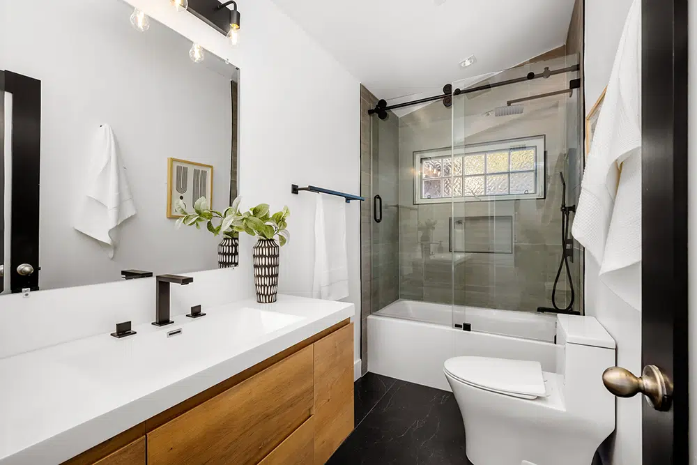 Newly renovated bathroom with glass shower, vanity, and modern fixtures in Wilson, NC.